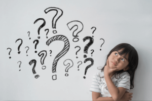 Girl making a thinking face surrounded by question marks