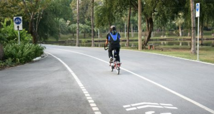 Person riding bike down a road in a community with strong infrastructure