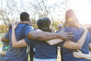 Nonprofit professionals standing with arms around one another