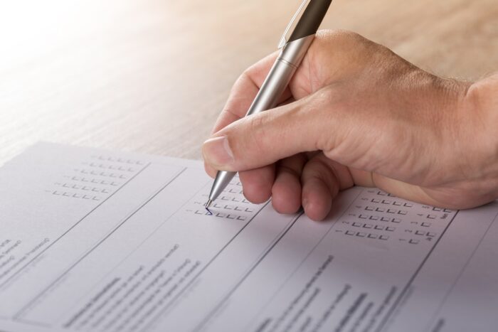 Picture of someone filling out a survey