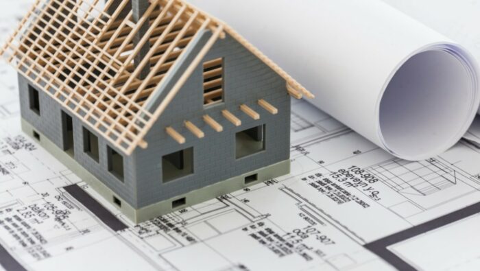 Image of small model of a home on top of blueprints