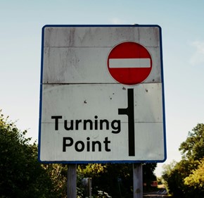 A road sign with a red circle and black text
