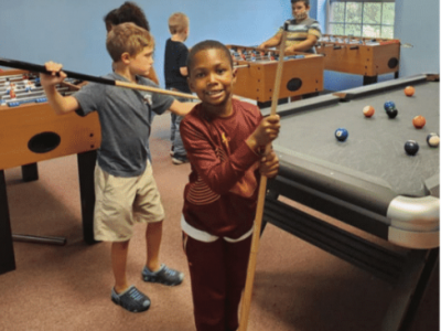 Child playing and smiling in the Boys and Girls club nonprofit